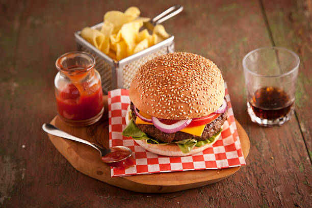 istock Classic cheeseburger onions, tomato and pickles sesame seed bun. 484226567