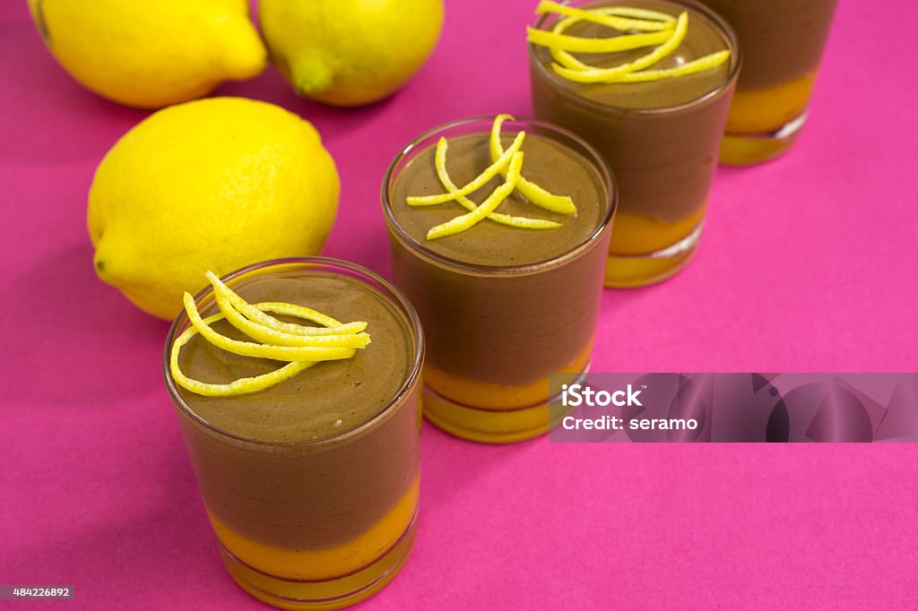 chocolate mousse on mango puree chocolate mousse on mango puree  decorated with lemon zest 2015 Stock Photo