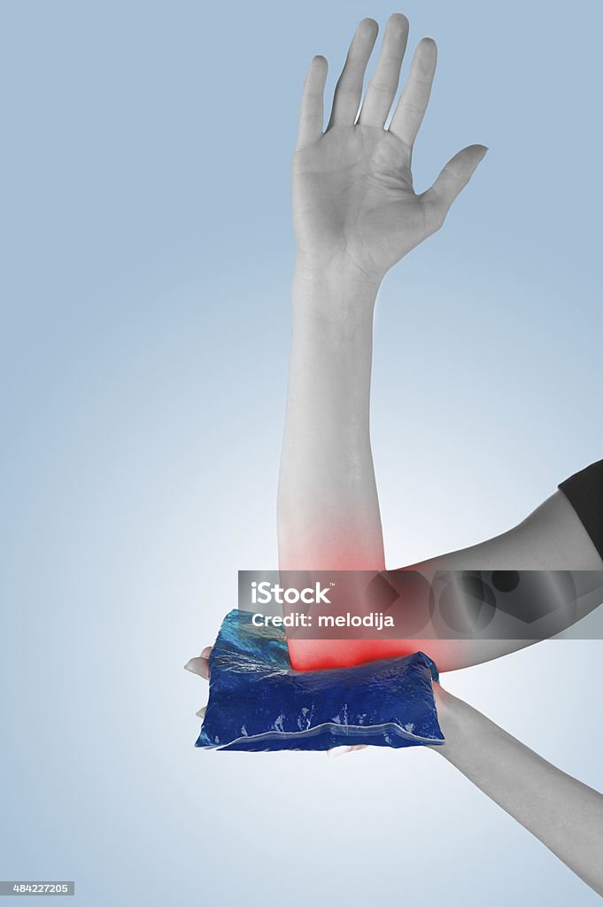 Holding ice gel pack on elbow. Medical concept photo. Woman holding ice gel pack on elbow. Medical concept photo. Adult Stock Photo