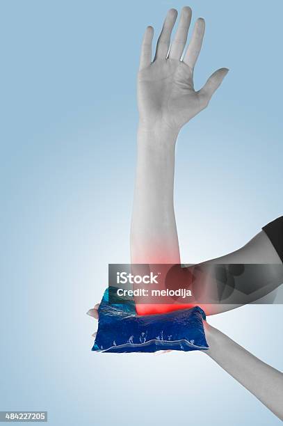 Holding Ice Gel Pack On Elbow Medical Concept Photo Stock Photo - Download Image Now