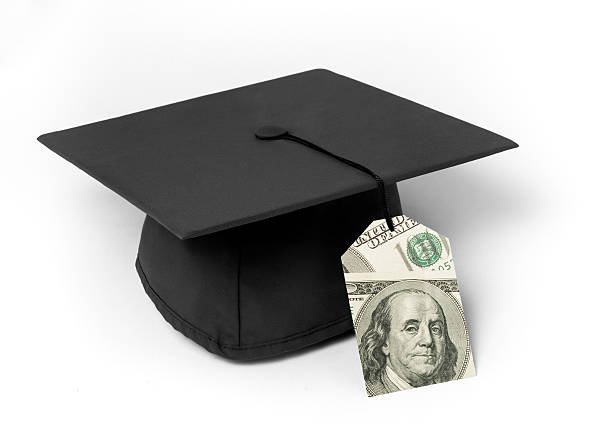 Mortarboard with dollar bill price tag stock photo
