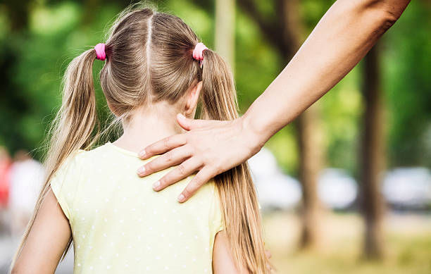 Mother encourages child while walking Mother is encouraging and supporting her daughter while walking. A closeup. Features genuine defocused background with shallow depth of field. AdobeRGB profile. Pigtails stock pictures, royalty-free photos & images