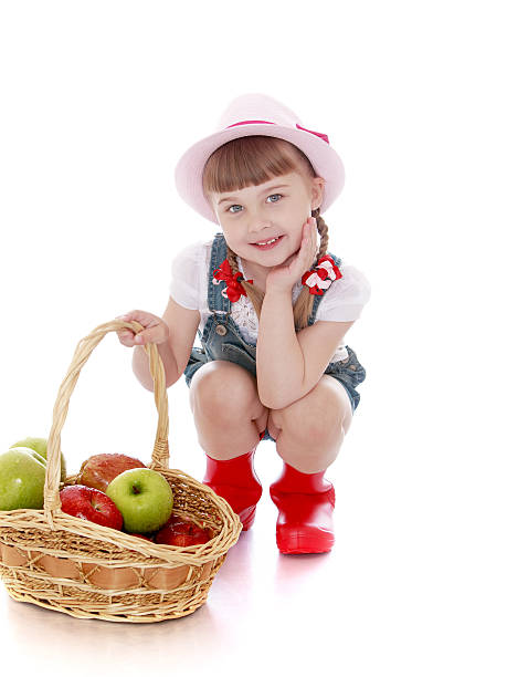 istock Girl with basket of apples 484258472
