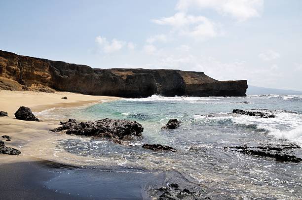 istock Cliff  over a white and black sand beach 484259558