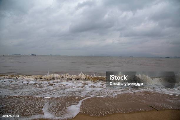 Waves Patting On Beach On An Overcast Day Stock Photo - Download Image Now - 2015, Accidents and Disasters, Backgrounds