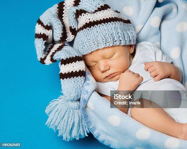 Baby Newborn Portrait Kid Sleeping In Blue Knitted Woolen Hat Stock Photo - Download Image Now
