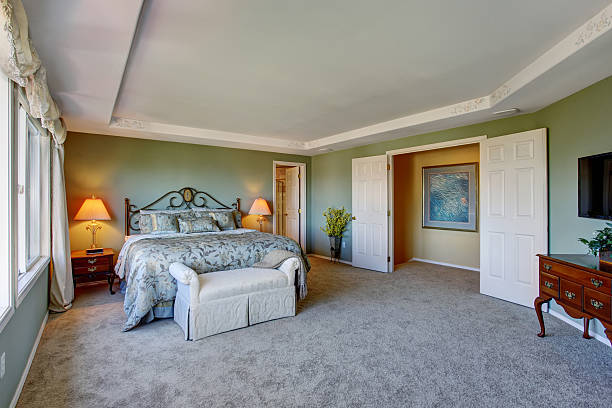 istock Amazing master bedroom with green interior, and two windows. 484264976
