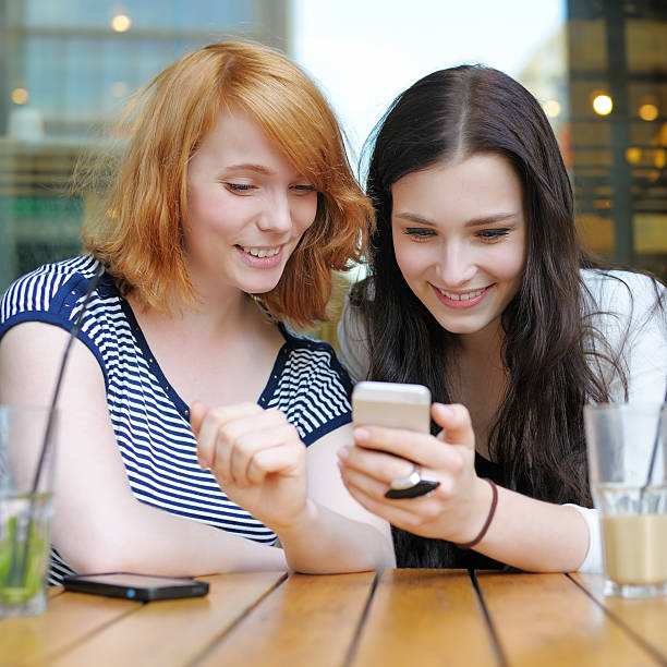 istock Two young girls using smart phone 484265472