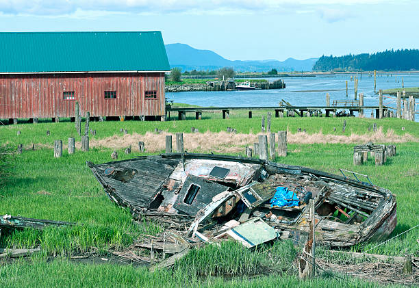 Rotting boat at old shipbuilding site on bay in Washington