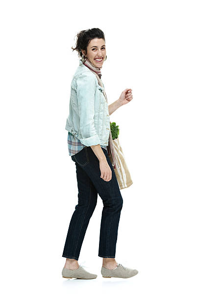 istock Cheerful woman holding vegetable bag 484266871
