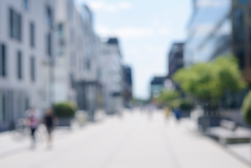 Defocused high res photograph of an urban street with pedestrians, Colgne Rheinauhafen, shot with a 85mm lens and full-frame DSLR.