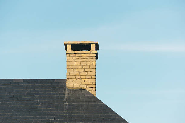istock chimney on house roof 484267899