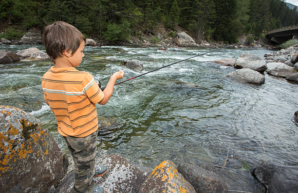 istock Child fishing in the river. 484267940