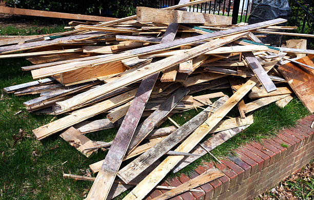 Renovation Debris Piled boards with nails at home remodeling site. Horizontal. work tool nail wood construction stock pictures, royalty-free photos & images