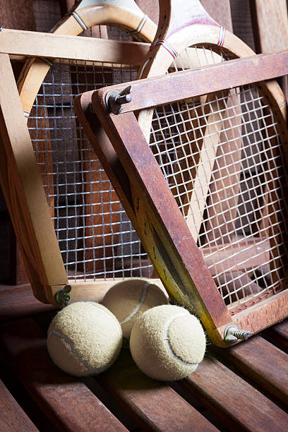 Vintage Tennis Racquets and ball Vintage Tennis Racquets with ball on bench wimbledon seats stock pictures, royalty-free photos & images