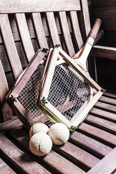 Vintage Tennis Racquets and ball Vintage Tennis Racquets with ball on bench wimbledon seats stock pictures, royalty-free photos & images