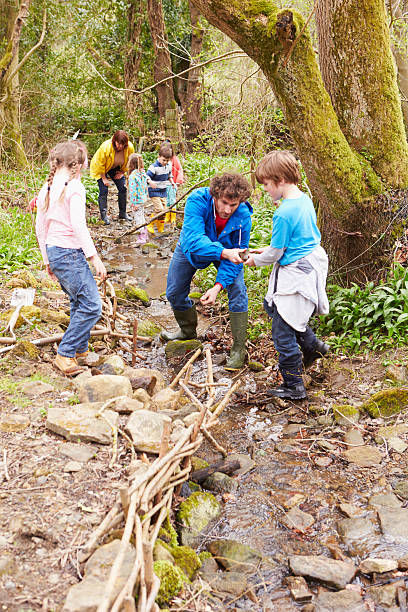 istock Children And Adults Carrying Out Conservation Work On Stream 484270526