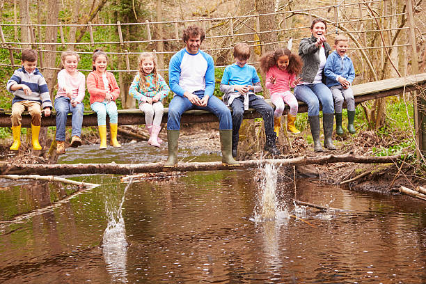 istock Adults With Children On Bridge At Outdoor Activity Centre 484270606