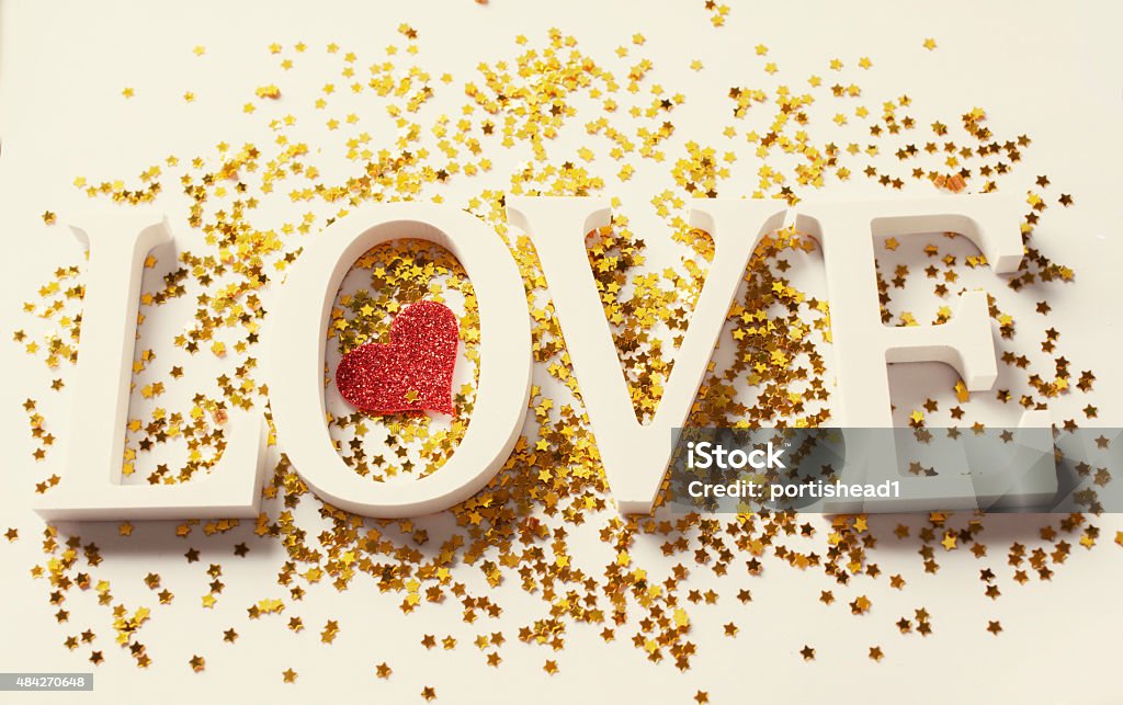 Love Word love, hearts in white, red heart  and golden stars background 2015 Stock Photo