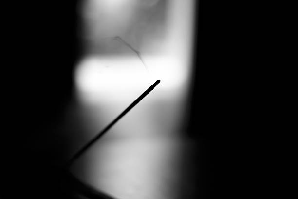 istock artistic photography, incense with light at background B/W 484272814