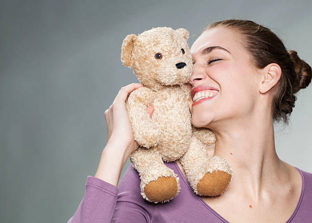 istock playful 20s girl cuddling her favorite comforter with emotion 484272990