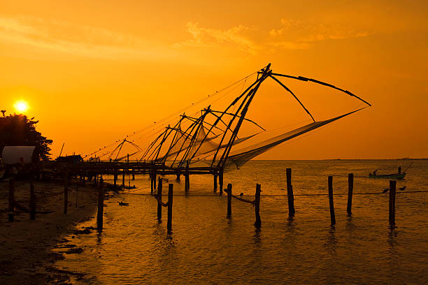 Chinese fishing nets Chinese fishing nets at sunset in Fort cochin, Kerala, India. cochin kerala india chinese fishing net stock pictures, royalty-free photos & images