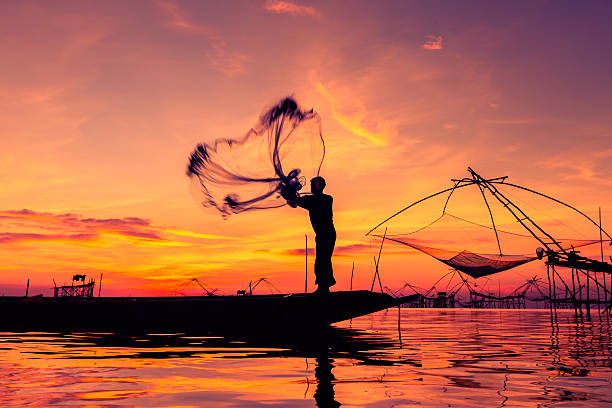 istock Throwing fishing net during sunset 484276960