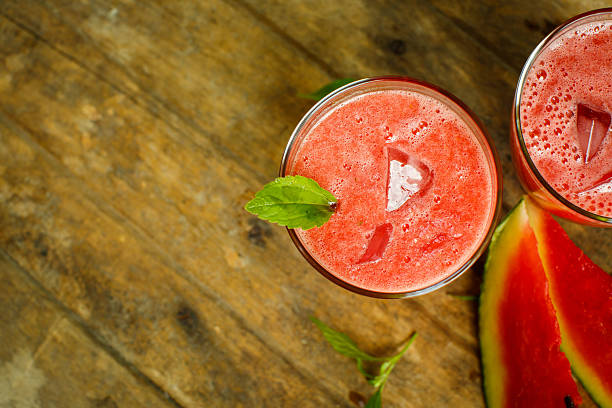 istock Watermelon juice on a wooden table. Space for text 484279772
