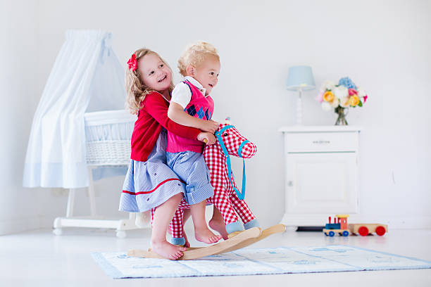 istock Kids playing with rocking horse 484280240