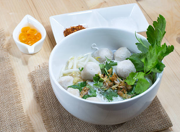 istock Noodle soup with pork balls, on wooden table 484281112