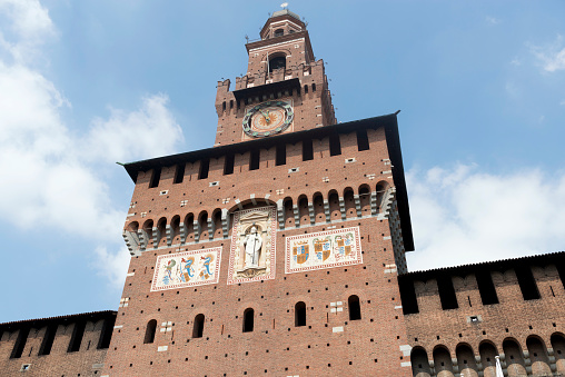 Milan, Italy - August 3, 2015: Exterior view of Sforza Castle in Milan during a summer day.  It was built in the 15th century by Francesco Sforza, Duke of Milan.
