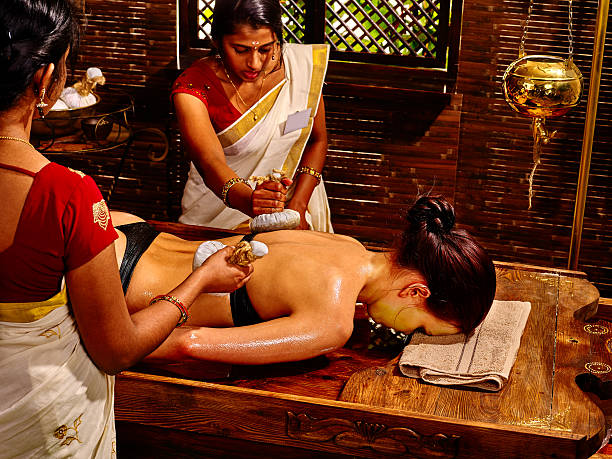 istock Woman having massage with pouch of rice 484285676