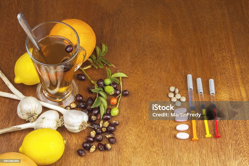 Rosehip tea and flu vaccination. Rosehip tea and flu vaccination. Traditional medicine and modern treatment methods. Injection of influenza vaccine. Household treatment of flu and colds. 2015 Stock Photo