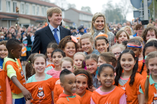 Enschede, Netherlands - APR 26, 2013: Royal Highness Queen Maxima and King Willem Alexander between schoolkids after they just opened the 'koningsspelen' on a school