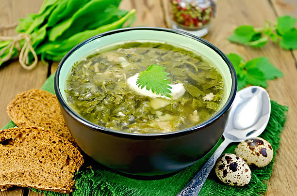 istock Soup green sorrel and nettles with a spoon on board 484292109