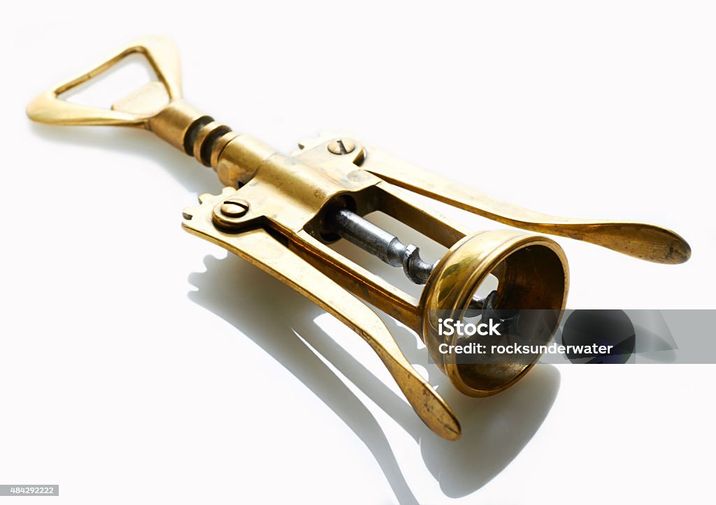 Wine Opener Brass bottle opener on white surface 2015 Stock Photo