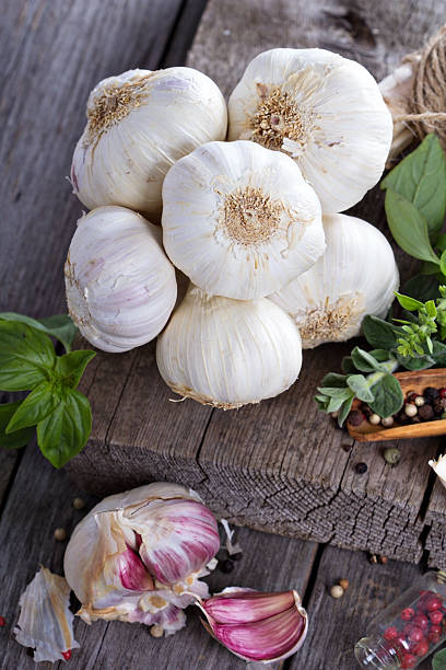 istock Garlic heads on a wooden table 484292709