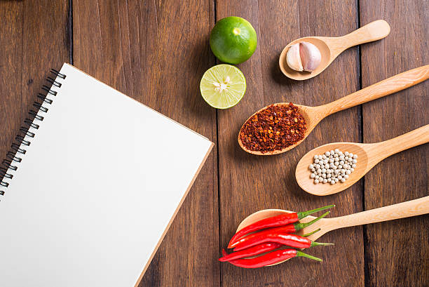 istock Recipe notebook, rice, Red chilli, garlic and lemon on wood 484296416