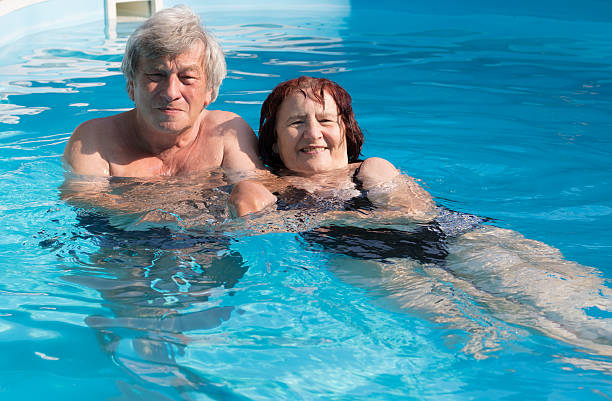 istock Senior couple in swimming pool 484297060