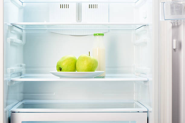 istock Two apples on plate and bottle of yoghurt in refrigerator 484299032