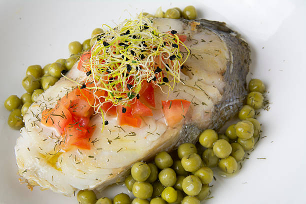 filetto di merluzzo con pomodoro e germogli, - catch of fish healthy eating hake food foto e immagini stock