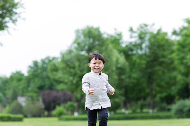istock run on the lawn asian boy 484302558