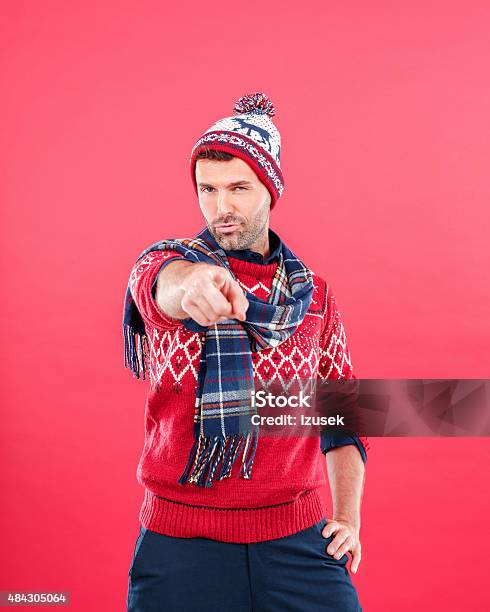 Happy Man In Winter Outfit Against Red Background Stock Photo - Download Image Now - Men, Red Background, 2015