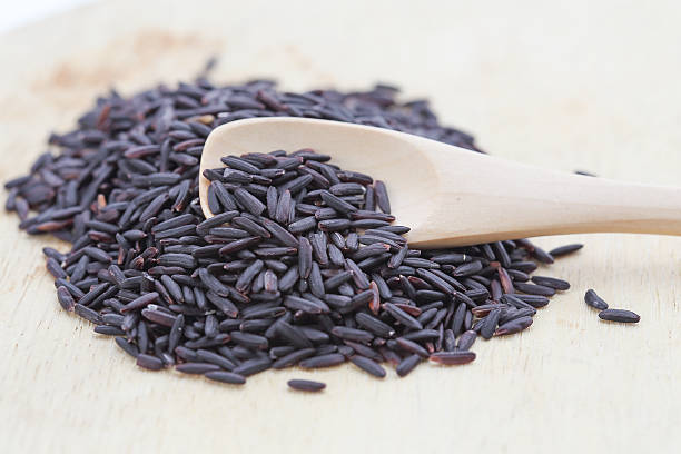 istock Black rice in wood  spoons 484310062