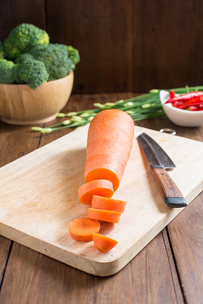 fresh carrot on cutting board on wooden background