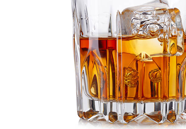istock Glass of whiskey and ice isolated on white background 484311007