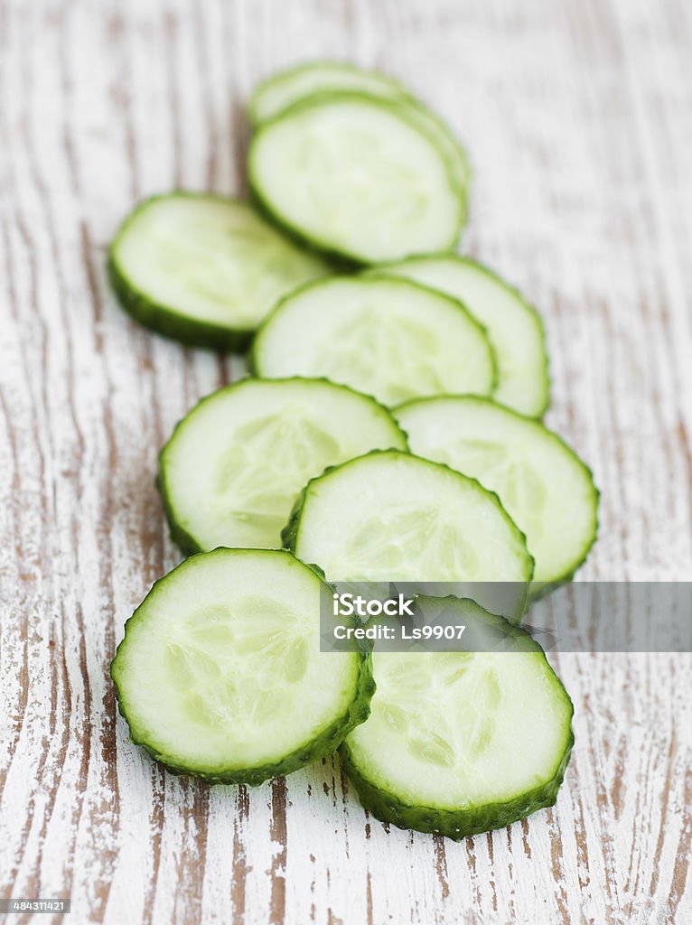 Sliced cucumber Sliced cucumber on a white wooden background Circle Stock Photo
