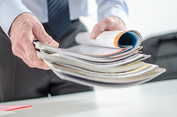 Businessman holding magazines