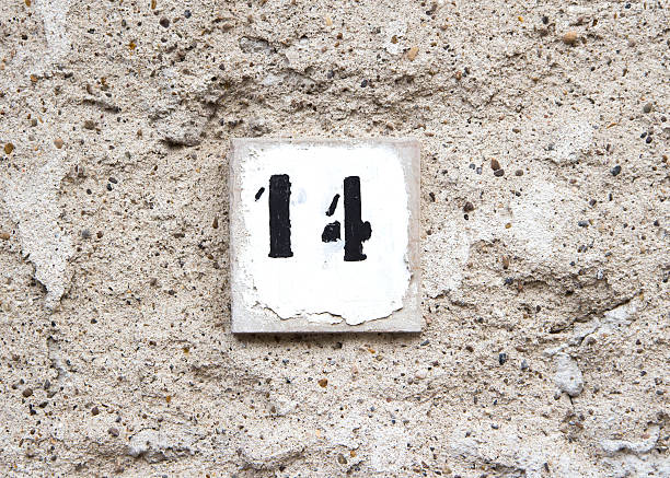 istock Number fourteen on old wall 484313163