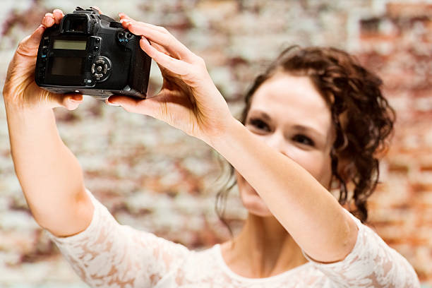 istock Female photographer taking a selfie 484316156